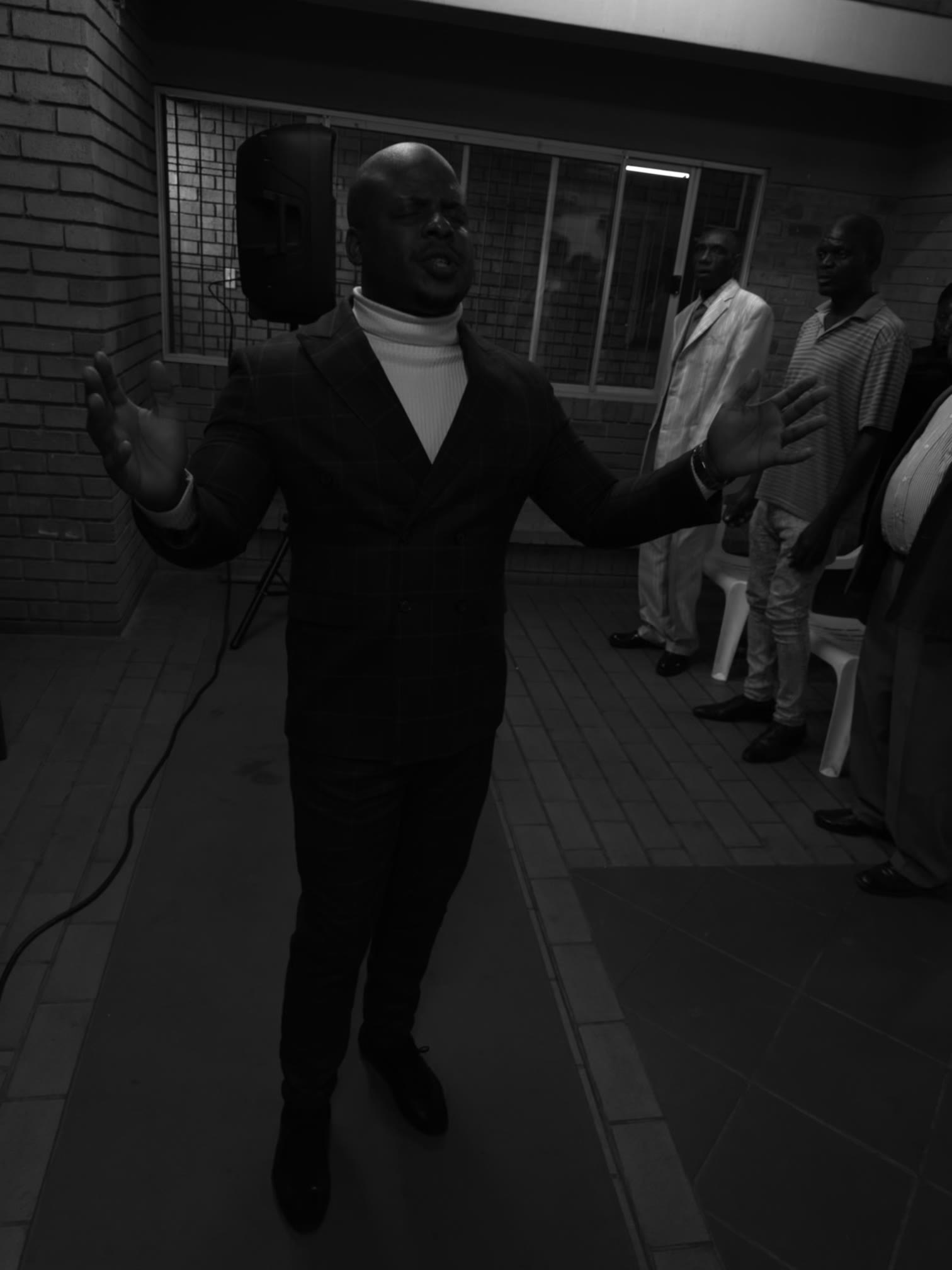 Prophet Matimba Nyandane standing with open hands during a worship moment