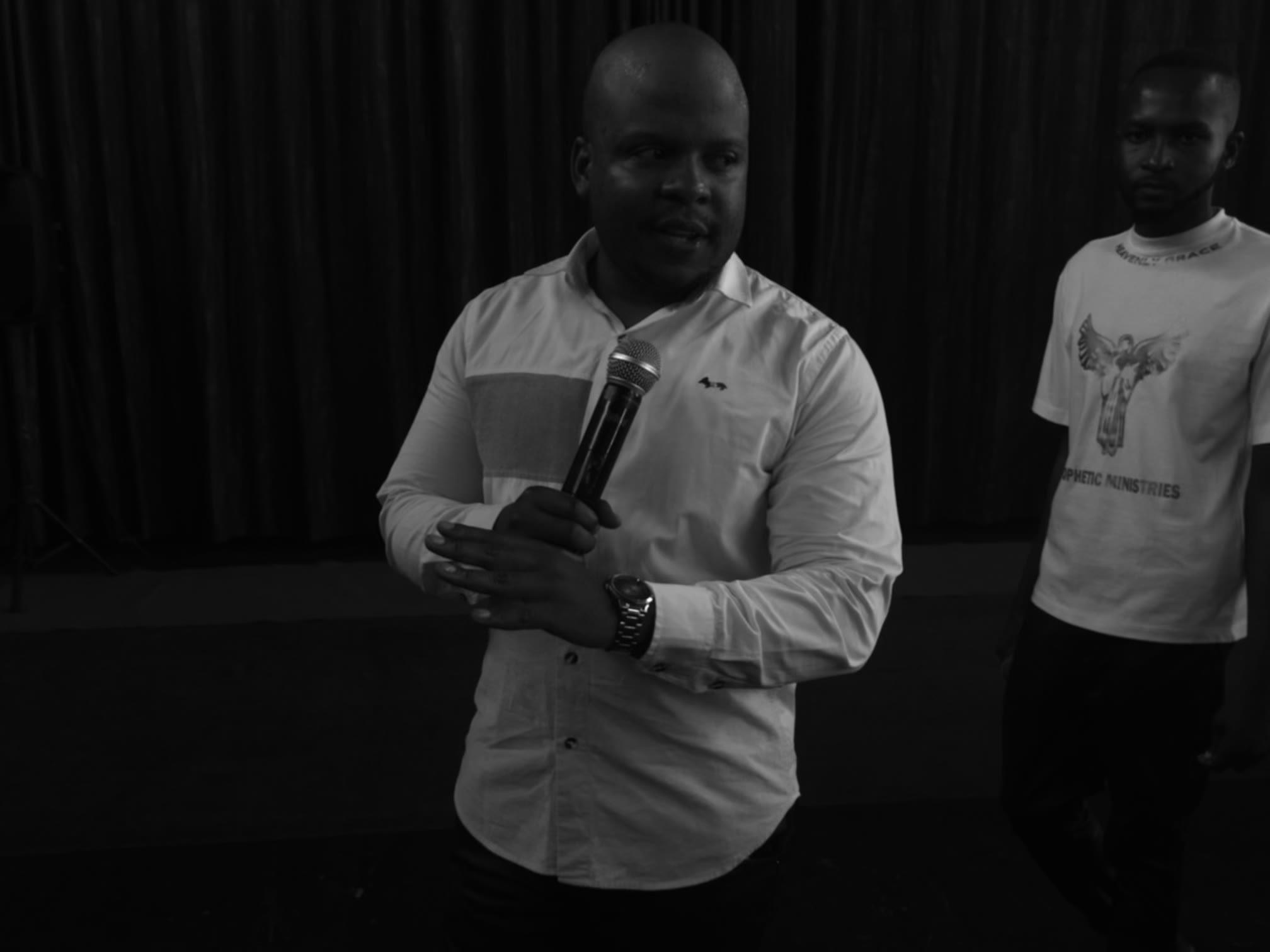 Prophet Matimba Nyandane speaking into a microphone during ministry